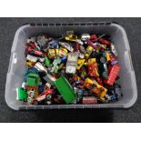 A plastic storage box of play worn die cast vehicles,
