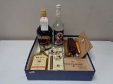 A box of assorted cigars, bottle of baileys,