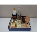 A box of assorted cigars, bottle of baileys,