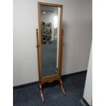 An Edwardian oak cheval mirror