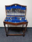 An Edwardian oak cutlery table and contents