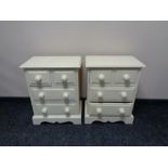 A pair of painted pine four drawer bedside chests