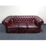 A three seater Chesterfield style oxblood leather club settee CONDITION REPORT: