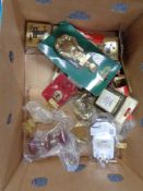 A box of wooden and brass door furniture, socket covers,