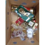 A box of wooden and brass door furniture, socket covers,