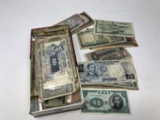 A tin of world banknotes,