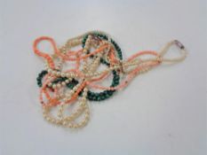 A bag of coral and pearl necklaces (two with 9ct gold clasps)