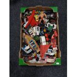 A box of mid century die cast vehicles, He-Man figure,