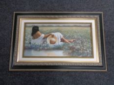 A print of a female figure lying in a field,