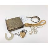 An engraved silver purse, a three-tone silver bracelet, silver necklace,