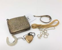 An engraved silver purse, a three-tone silver bracelet, silver necklace,