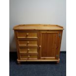 A pine single door sideboard fitted four drawers