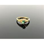 A 14ct gold emerald and diamond ring,