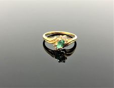 A 14ct gold emerald and diamond ring,