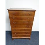 A mid century continental seven drawer chest