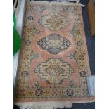 A fringed eastern rug of geometric design