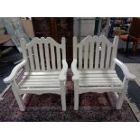 A pair of painted wooden garden armchairs