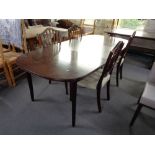 A mid century extending oval dining table and four chairs.