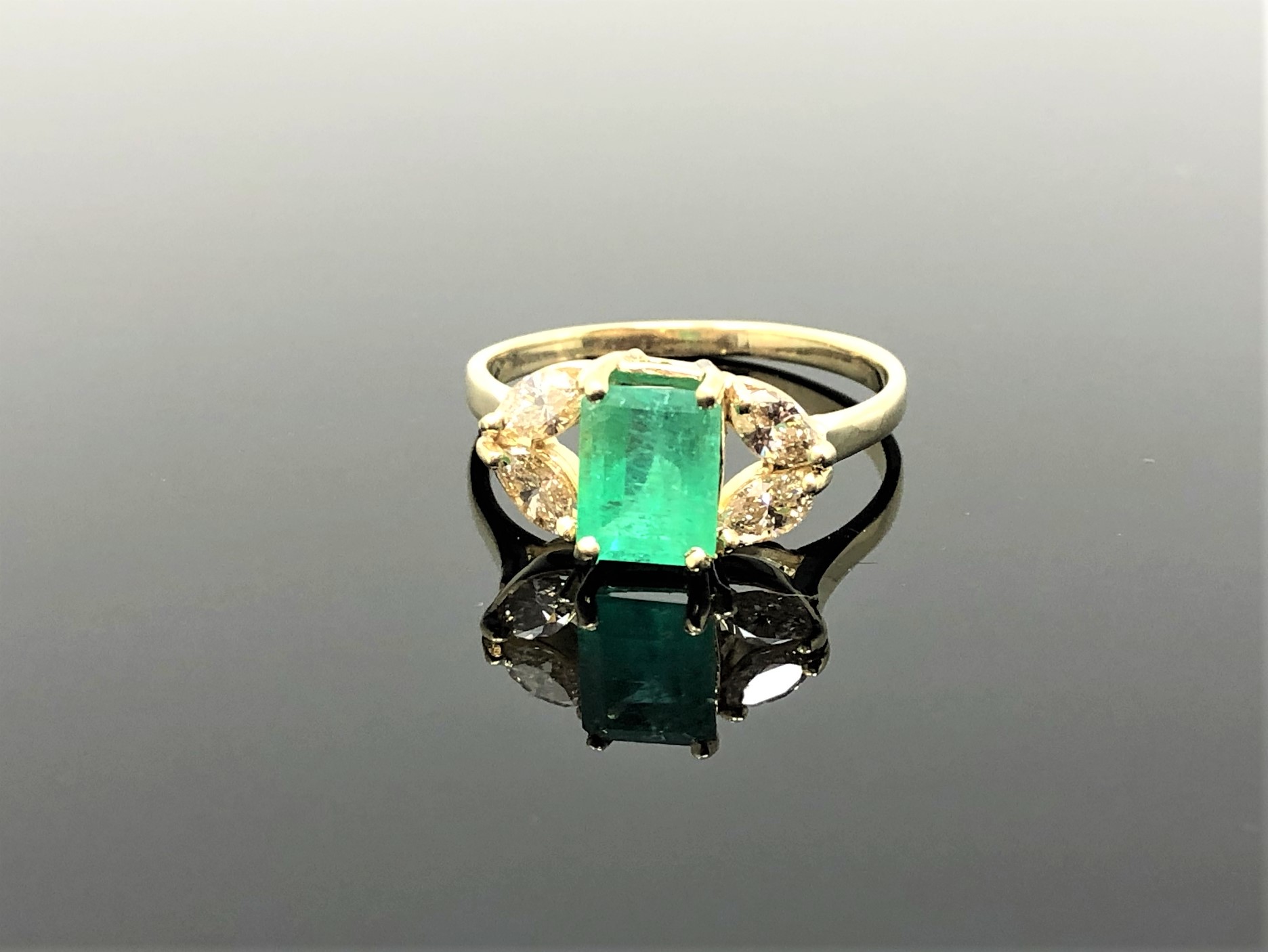 A fine quality 18ct gold emerald and marquise diamond ring,