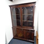 A mahogany double door bookcase fitted with three cupboards