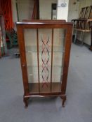 A 1930's walnut display cabinet