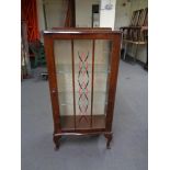 A 1930's walnut display cabinet