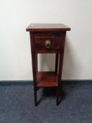 An indonesian mahogany plant stand fitted with a drawer