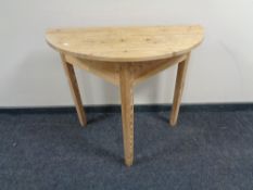 An antique pine D-shaped table