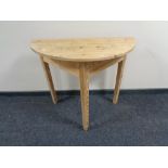 An antique pine D-shaped table