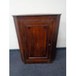 A George III oak hanging corner cabinet