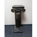 A plaster pedestal plant stand