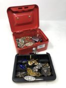 A cash tin with key containing two silver brooches, silver fob, cuff links and costume jewellery,