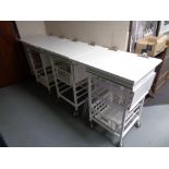 Three metal medical trolleys with trays and baskets