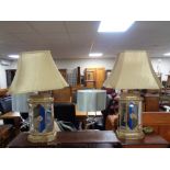A pair of contemporary gilt mirrored table lamps with shades