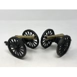 A pair of brass and metal cannons