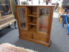 A Parker Knoll leaded glass door bookcase (a/f)
