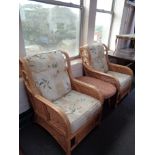 A pair of conservatory chairs and a small wicker low table