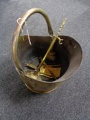 An antique brass coal bucket and companion set