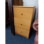 A pine effect three drawer chest