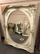 A large white oval panel mirror