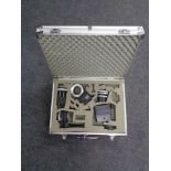 An aluminium camera case containing vivitar camera lens and camera accessories