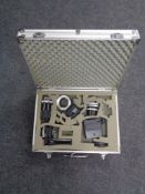 An aluminium camera case containing vivitar camera lens and camera accessories