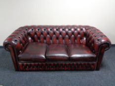 A three seater Chesterfield style oxblood leather club settee CONDITION REPORT: