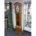 An oak cased Tempus Fugit longcase clock with pendulum and weights