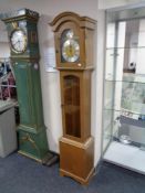 An oak cased Tempus Fugit longcase clock with pendulum and weights