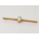 A yellow gold opal bar brooch