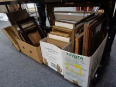 Four boxes of antique and later picture frames, framed prints,