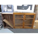 A glazed kitchen cabinet together with a further wooden bookcase