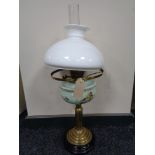 An antique brass Corinthian column oil lamp with hand painted glass reservoir,