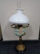 An antique brass Corinthian column oil lamp with hand painted glass reservoir,